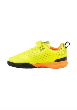 Zapatilla deportiva amarilla y naranja con suela negra, detalles perforados, una correa de velcro y una lengüeta en el talón.