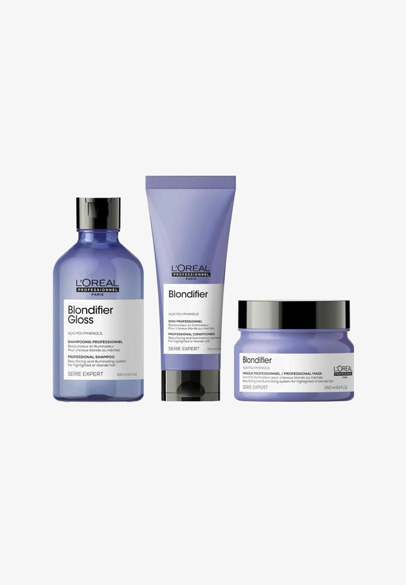 L'Oréal Professionnel Blondifier Haarpflege-Set mit Shampoo, Conditioner-Tube und professionellem Masken-Glas in lila und schwarzen Behältern.