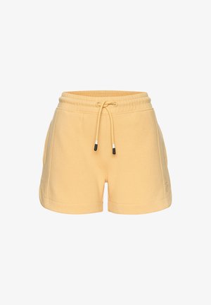 Yellow cotton shorts with an elastic waistband, drawstring, side pockets, and embroidered logo detail on one leg.