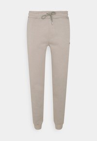 Light beige sweatpants made of soft fabric, featuring an elastic waist with a drawstring, tapered legs, and a small logo detail.