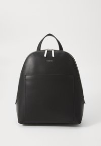 Black leather backpack with a rounded shape, front pocket, dual silver zippers, and a top handle for carrying. Minimalist design.