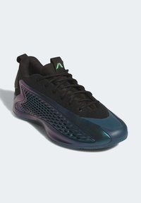 Black athletic shoe with a textured mesh upper, iridescent purple and teal accents, and a distinctive geometric pattern on the side.