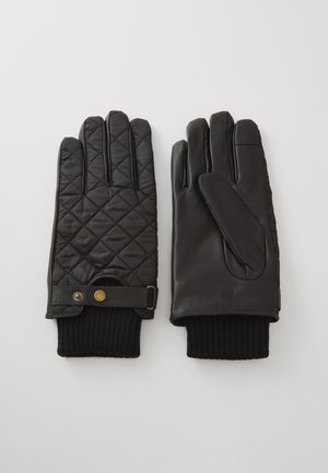 Zwarte gewatteerde handschoenen met leren handpalmen, geribbelde gebreide manchetten en een band met een gouden drukknoopdetail. Glad oppervlak, klassiek ontwerp.