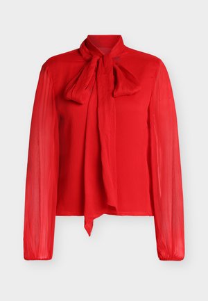 Red long-sleeve blouse with a bow tie collar, featuring a sheer texture and ribbed design. Lightweight and slightly fitted at the waist.