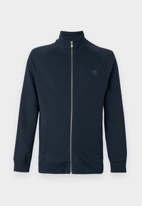 Μπουφάν με πλήρες φερμουάρ σε ναυτικό μπλε, με ψηλό γιακά, μακριά μανίκια, πλαϊνές τσέπες και μικρό κεντητό λογότυπο δέντρου στο αριστερό στήθος.