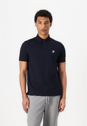 Marineblå polo skjorte laget av bomull med en tre-knappers skråstik og korte ermer, med en liten brodert logo på brystet.
