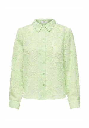 Chemise vert clair avec un motif texturé et duveteux, dotée d'un devant à boutons, d'un col et de manches longues. Matière douce et légèrement transparente.