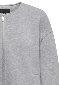 Gray bomber jacket made from soft, textured fabric. Features a zip closure and side pockets with a simple, clean design.