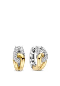 Gold- und Silber-Ohrringe mit ineinander verschlungenen Designs, akzentuiert mit klaren Edelsteinen für einen funkelnden Effekt und hervorgehoben durch glatte Texturen.