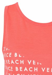 Coral tank top with a round neck, made of soft fabric, featuring white text print that repeats phrases about "Venice Beach."