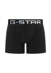 Zwarte boxers met een strakke pasvorm, gemaakt van een katoenmix, met een wit "G-STAR" logo op een zwarte tailleband.