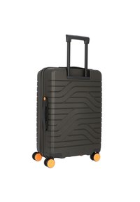 Valigia rigida grigia scuro, con motivi a onda, manico nero e ruote arancioni. Manico estraibile per un facile spostamento.