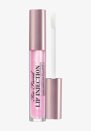 Translucente roze lip plumper in een heldere tube, met een metallic roze dop. Inclusief een witte applicator. Tekst: "Too Faced Lip Injection."