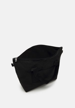 Bolso tote negro de tela, con cierre en la parte superior, asas resistentes y un bolsillo frontal. Textura suave y forma rectangular.