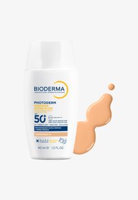 Crema solare Bioderma Photoderm XDefense Ultra-Fluid in flacone bianco da 40 ml. Fluido marrone chiaro accanto al flacone, con etichetta SPF 50+.