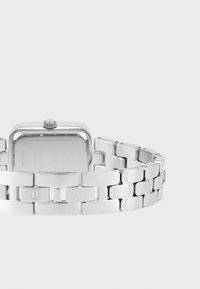 Silver stainless steel watch with a rectangular case and a linked bracelet. Features a textured surface, engravings, and a winding crown.