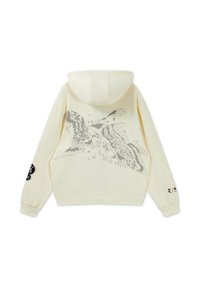 Sweat à capuche crème avec un graphique détaillé d'aigle gris et de faucon au dos, des écussons sur la manche droite, et un petit texte sur le poignet gauche.