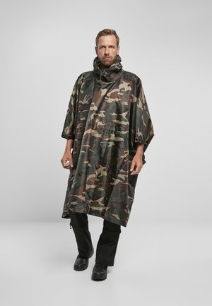 Poncho de camouflage en matériau léger et imperméable ; il dispose d'une capuche, d'un cordon de serrage pour la capuche et d'une coupe ample et drapée pour faciliter les mouvements.