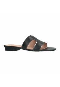 Black leather slide sandal with two cut-out design features, flat sole, and contrast stitching. Minimalist style with a low heel.