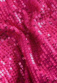 Fuchsia paljett tyg med tätt packade, glittrande rund paljetter som skapar en texturerad, reflekterande yta med varierade nyanser.