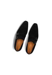 Black suede shoes with a pointed toe design, featuring a silver buckle accent and orange insoles. Smooth texture contrasting with matte finish.