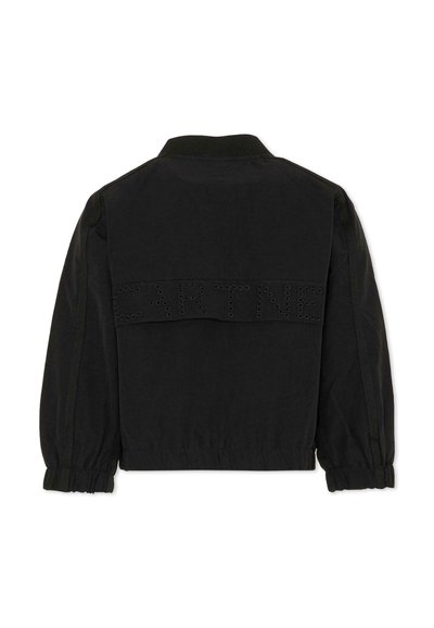 Veste noire à manches longues avec poignets élastiques, col côtelé, et détail texte "CARTINE" en œillets métalliques sur le haut du dos.