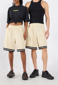YOURTURN by Zalando - UNISEX - Tracksuit bottoms - off-white Thumbnail Image 1