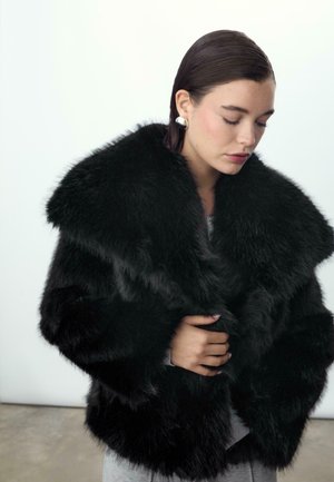 Cappotto in pelliccia sintetica nera con un ampio colletto, superficie testurizzata e aspetto morbido. Include un design morbido e una silhouette drammatica.