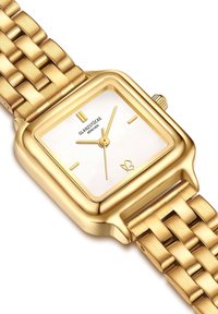 Kuldne ruudukujuline kell valge näo, õhukeste kuldsete käte ja kuldse tekstuuriga rihmaga. Näidatud brändinimi "GLANZSTÜCKE" nägu.