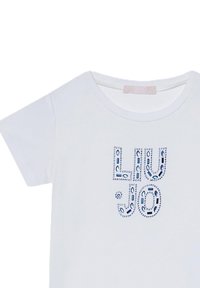 Maglietta bianca a maniche corte con testo decorativo blu e accenti di strass che spellano "LIU JO". Collo rotondo, texture del tessuto morbida.