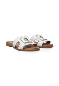 Witte sandalen met een soepel leren bovenwerk, open ontwerp, goudkleurige rechthoekige gespaccent en een bruine platte zool. Antislipstructuur op de zool.