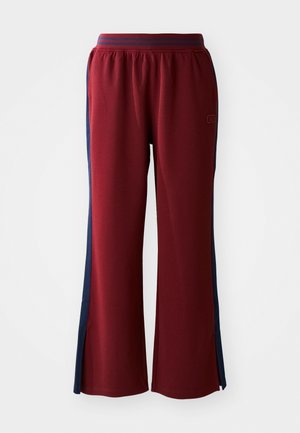 Røde sweatpants med en løs pasform, med marineblå sidelister og et bredt ben design. Elastisk talje for komfort.
