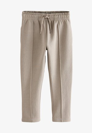 Pantaloni de trening bej cu talie elastică, șnur ajustabil, buzunare laterale și material texturat; picioare conice și design plissetat.