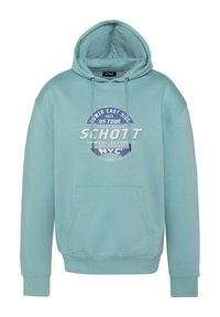 Sudadera de color verde claro con un bolsillo frontal, capucha con cordón y un gráfico circular impreso que presenta "Schott" y detalles de ubicación. Material suave.