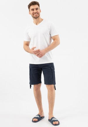 White V-neck t-shirt, navy cargo shorts with two side pockets, and blue slide sandals with white text. Casual, simple design and fit.