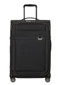 Valise noire avec un extérieur en tissu texturé, poignée latérale, poignée rétractable, poche avant et quatre roulettes pivotantes pour une meilleure mobilité.