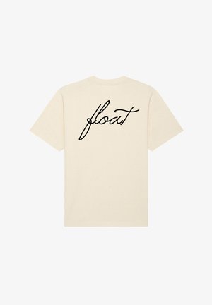 T-shirt en coton couleur crème à manches courtes, avec un design noir écrit à la main "float" imprimé au dos.