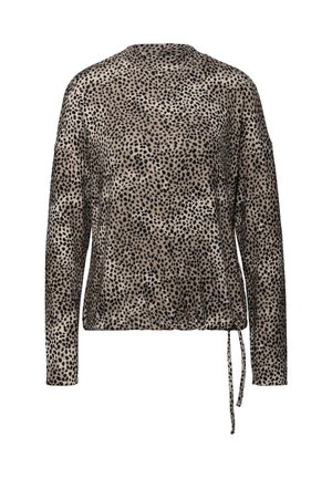 Blusa de manga larga en beige con un patrón de manchas negras, que presenta un detalle de lazo en la cintura y una silueta de corte relajado.