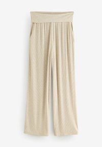Pantalons larges beige côtelés avec une taille élastique et des poches latérales. Le tissu semble doux et léger, idéal pour un usage décontracté.