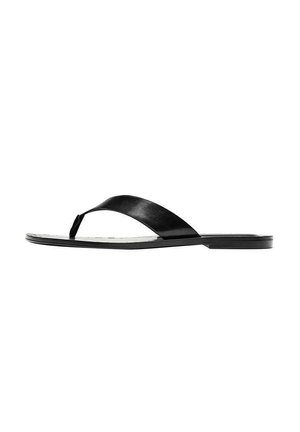 Sandale plate noire avec une large bride unique et un entre-doigt sur fond blanc, vue latérale montrant un design minimaliste et élégant.