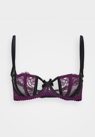 Sutiã preto e roxo em renda com painéis transparentes, padrões florais e bordas rendadas. Finalizado com um laço central e alças ajustáveis.