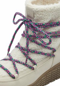 Witte fleece enkellaars met pastelgekleurde vlechtveters in paars, groen en roze. Beschikt over een gestructureerde zool en een gladde leren basis.