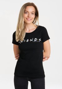 Black cotton t-shirt with short sleeves and a round neckline, featuring "FRIENDS" text in colorful letters across the chest.