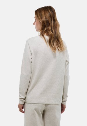 Sweatshirt beige à manches longues avec une coupe décontractée. Texture lisse, encolure ras du cou et coutures discrètes. Associé à un pantalon beige assorti.