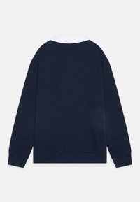 Felpa blu navy con colletto bianco, maniche lunghe, polsini a costine e una consistenza liscia senza motivi o dettagli visibili.