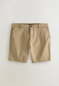 Short beige décontracté en coton avec fermeture par boutons, passants pour ceinture et poches latérales, posé à plat sur une surface blanche.