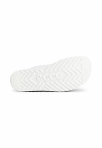 Suola di scarpa bianca con motivo di grip a zigzag, branding e finitura texturizzata. La suola esterna è solida con una leggera curvatura nella zona della punta.