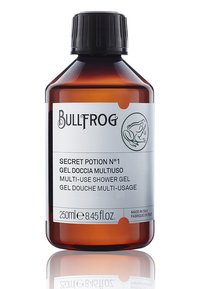 Bottiglia in vetro ambrato con tappo nero. L'etichetta presenta un'icona di rana, il nome del prodotto "Secret Potion N°1" e un testo multilingue. Capacità di 250 ml.