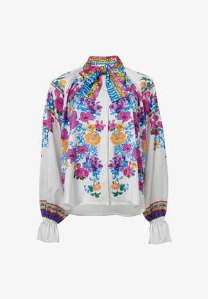 Lange mouwen blouse van witte stof met kleurrijke bloemenpatronen in roze, blauw en geel, met een gestrikte hals en elastische manchetten.