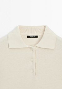 Crèmewit gebreid poloshirt met geribde kraag en drie bijpassende knopen, gelabeld Massimo Dutti, gemaakt in China.